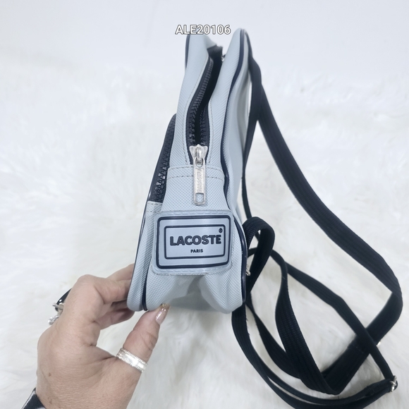 Lacoste mini backpack in a soft light blue shade with navy blue trim accents. - Picture 15 of 16